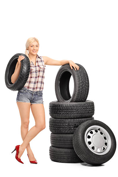 istock Female mechanic holding a car tire 497567954