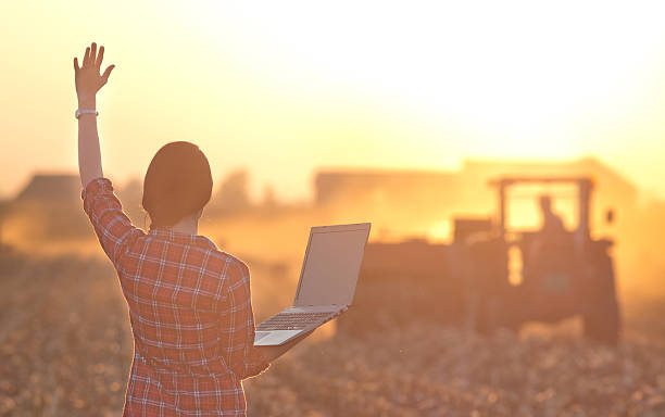 istock Woman with laptop and tractor 497568306
