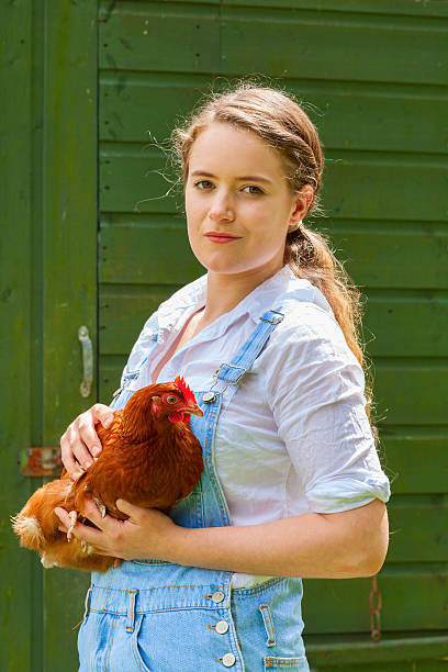 istock Farm Girl Holding A Hen 497568323