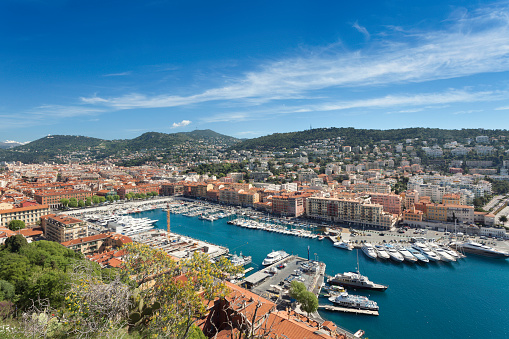 City of nice. Port of the city with small boats and buildings behind it. Blue sea