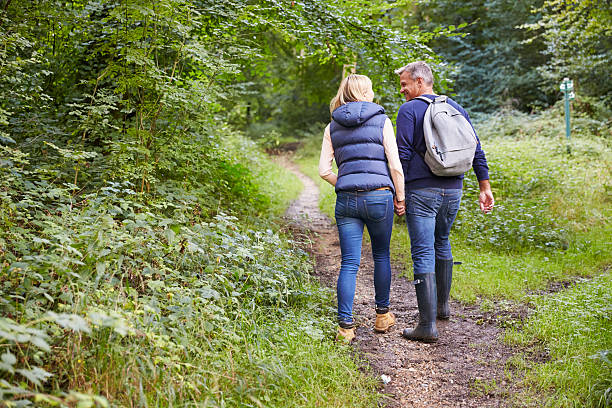 Mature Couple On Walk Through Beautiful Countryside