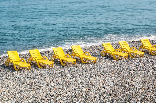 Beach yellow chairs or beds on the beach near sea