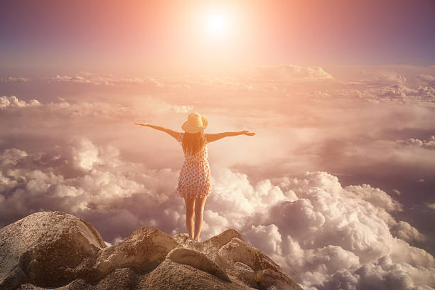 istock freedom young  woman jumping on mountain peak rock 497569262