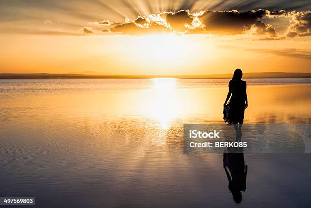 Walking On Water Stock Photo - Download Image Now - Women, Sunset, One Woman Only