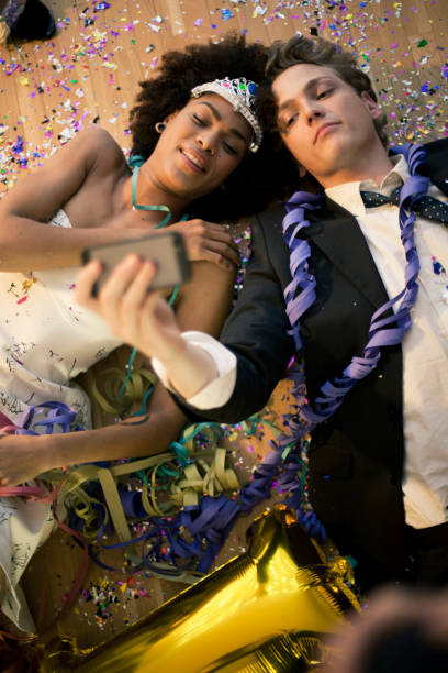 Couple lying down on the floor taking a selfie