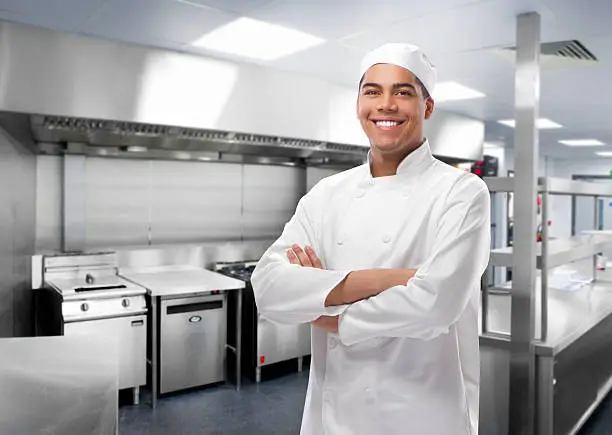 happy trainee chef in modern kitchen