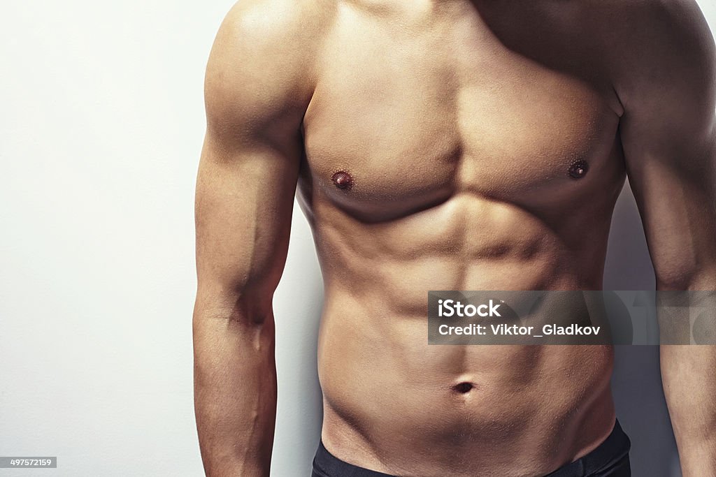 Muscular torso of young man Very muscular and sexy torso of young man with copy space Men Stock Photo