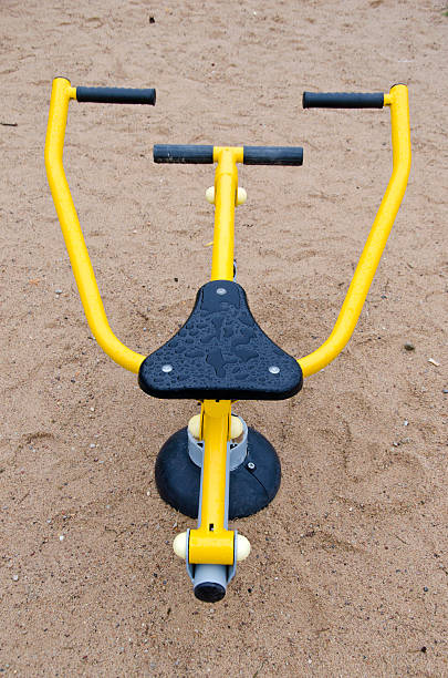 istock Black and yellow exercise equipment in playground 497574256