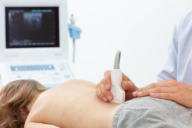Child's lower back diagnosis  with ultrasound Child's lower back diagnosis carried out with the use of an ultrasound animal internal organ photos stock pictures, royalty-free photos & images