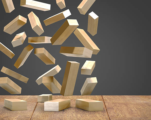 Wood blocks fallingon wood floor black background.