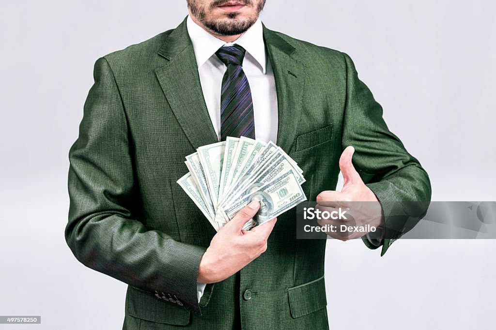 Businessman money Man in green suit showing dollar bills  2015 Stock Photo