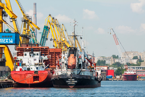 Сonstanta, Romania - May 27, 2014: Cargo ships docked for loading in industrial port quay of Constanta, the largest on the Black Sea and the 18th largest in Europe.