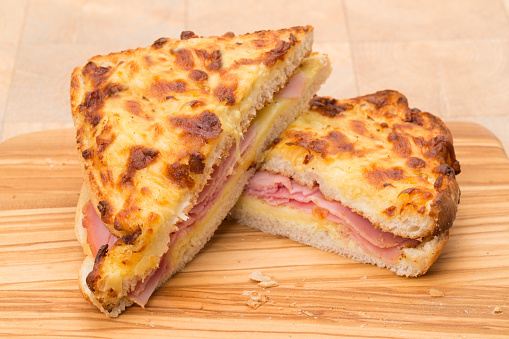 A toasted cheese and ham sandwich or panini - studio shot