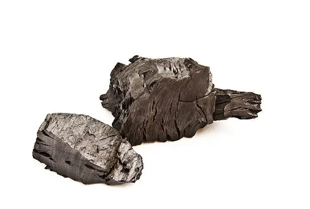 Piece of fractured wood coal isolated over white background