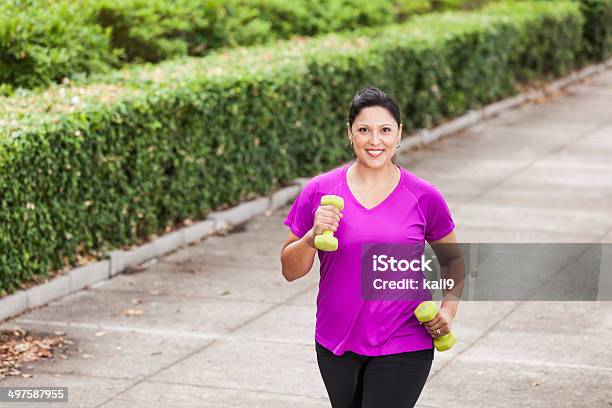 Hispanic Woman Exercising In Park Stock Photo - Download Image Now - 30-39 Years, 35-39 Years, Active Lifestyle