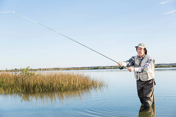 istock Senior man fly fishing 497587965