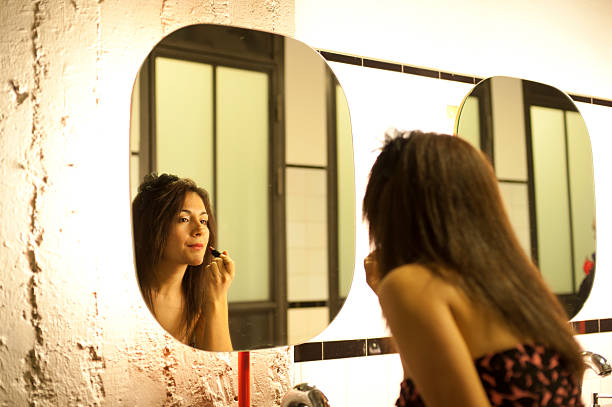 istock girl looking at the mirror 497595309