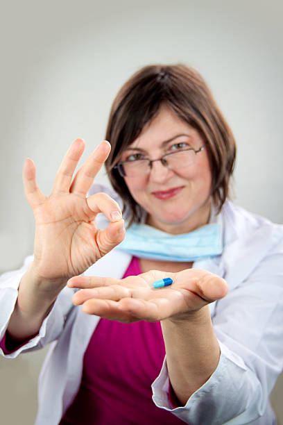 istock Woman doctor holding blue pill 497595447