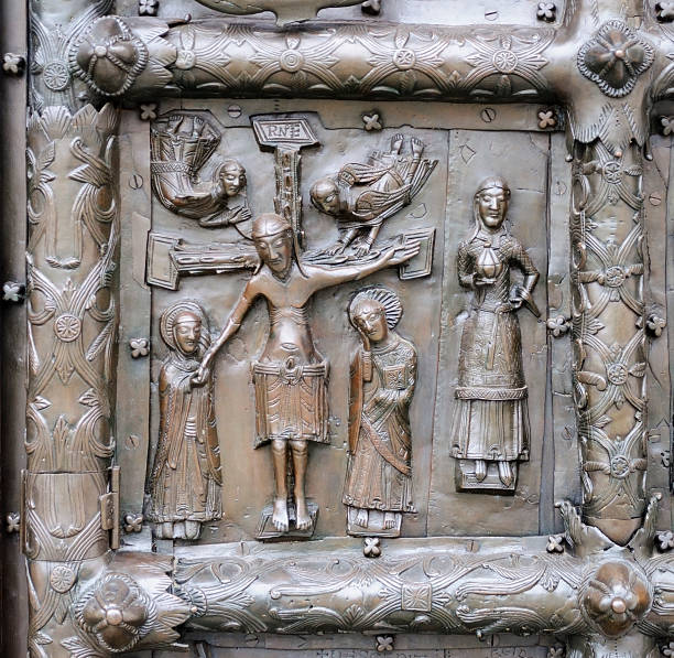 Ancient bronze gates of Magdeburg in Veliky Novgorod, Russia. Fragment of the bas-relief with Jesus crucified on the cross.