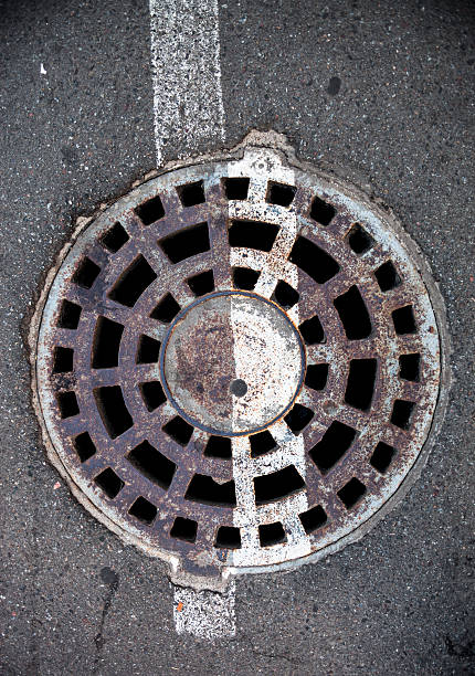 istock Manhole with white road marking line 497598159