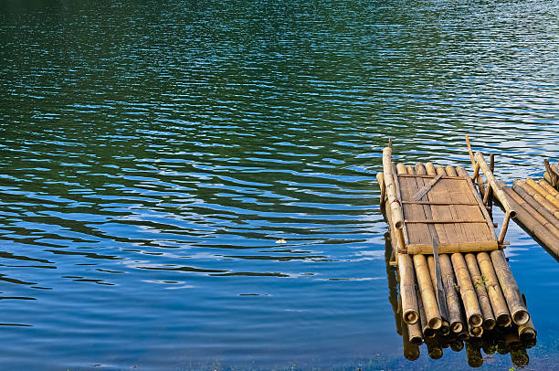 istock Bamboo raft floating on blue calm water in Pang-Oong reserve 497600621