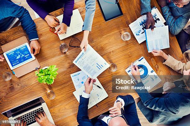 Papers Are Passed In A Business Meeting Stock Photo - Download Image Now - Meeting, Sales Occupation, Business Meeting