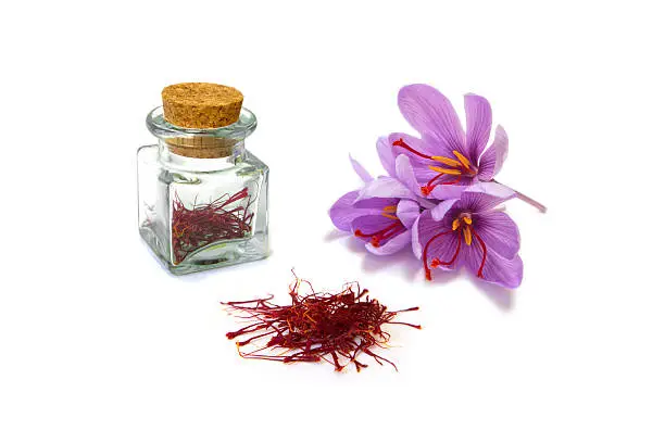 An image of saffron flowers, dried saffron and saffron stored for use.