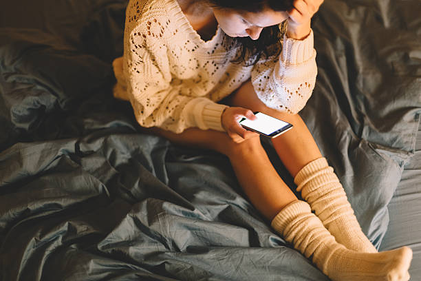 istock Girl in bed texting on smartphone 497601156