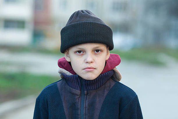 istock dramatic portrait of a little homeless boy 497601218