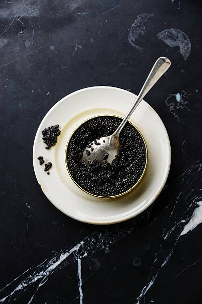 istock Sturgeon black caviar in can and spoon 497602310