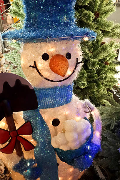 istock Smiling cheerful snowman with a shovel in a blue hat 497602688