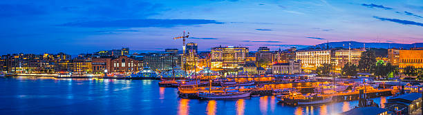 istock Oslo harbour sunset illuminated landmarks Aker Brygge waterfront panorama Norway 497603290