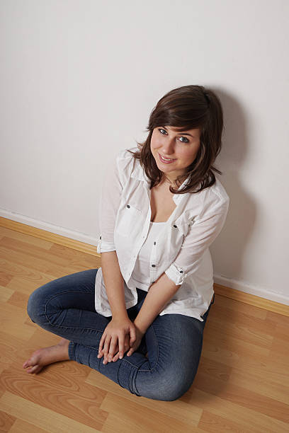 istock girl sitting on floor 497605782