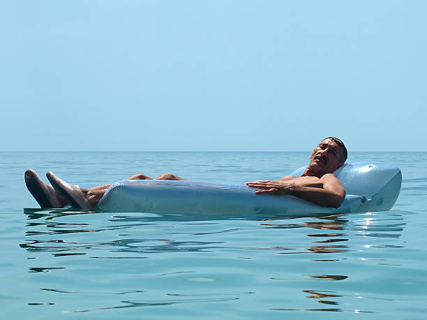 istock Senior man relaxing on water mattress 497606606
