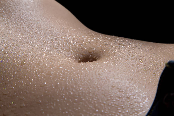 istock Woman's belly in the dark 497607326