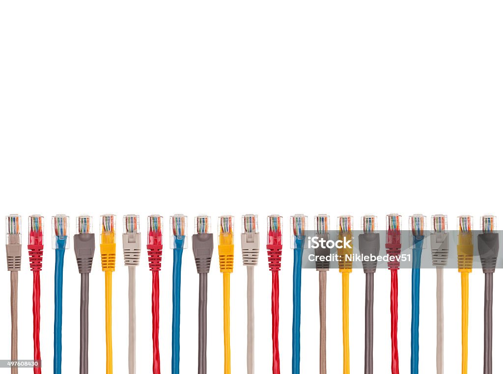 Multicolored internet cables are arranged parallel in a row Multicolored internet cables are arranged parallel in a row. At the ends of the connectors RJ-45. Isolated on a white background. Cut Out Stock Photo