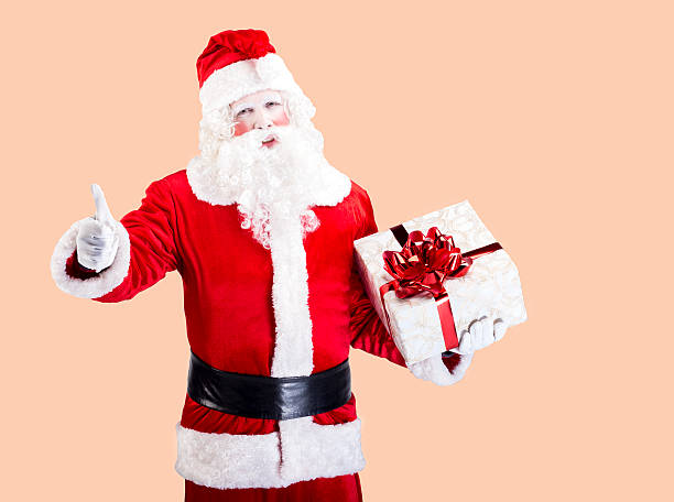 istock Santa Claus with gift posing on color background 497608480