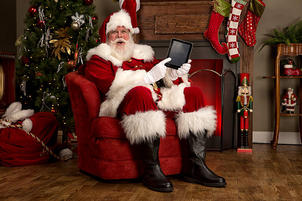 Portrait of the Real Santa Claus holding digital tablet stock photo