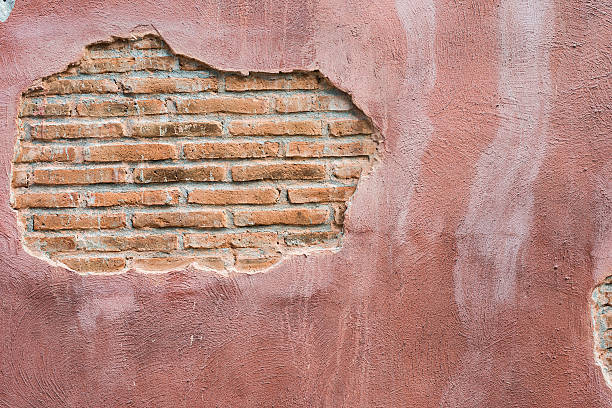 istock cracked concrete vintage brick wall background.with space for text 497609856