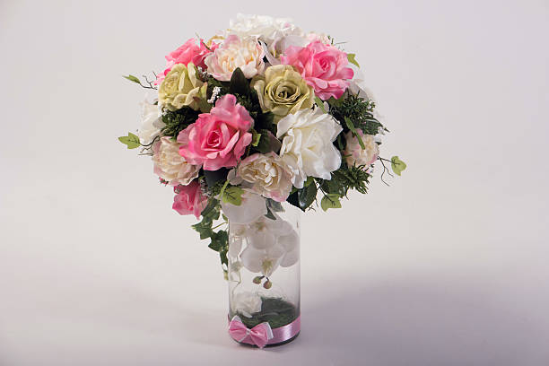 istock Artificial flowers bouquet in the vase isolated on white 497610828