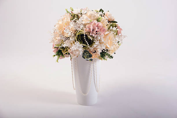 istock Artificial flowers bouquet in the vase isolated on white 497610938