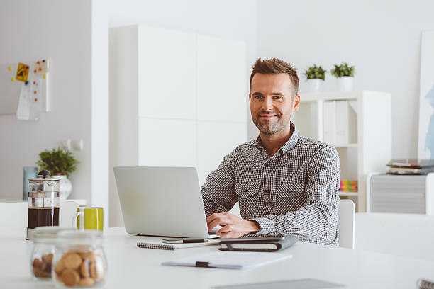 istock Man working on laptop in a home office 497611978