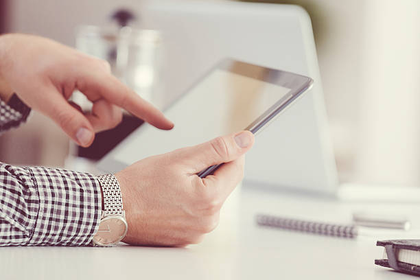 istock Man using digital tablet, close up of hands, unrecognizable person 497612554