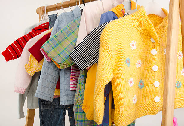 Colorful dressing closet of newborn, kids, babies full of all clothes.