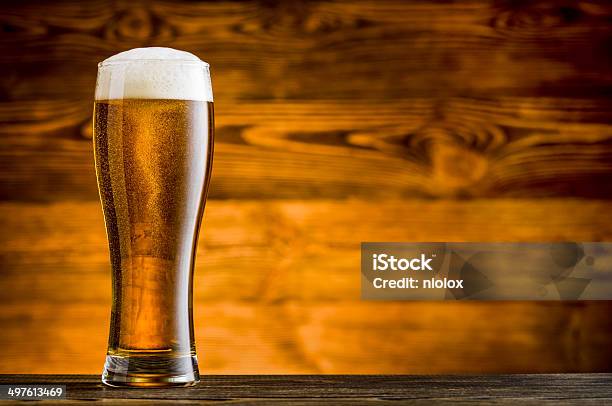 Glass Of Beer On Wooden Table And Wooden Background Stock Photo - Download Image Now