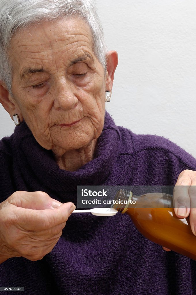 senior woman taking syrup 2015 Stock Photo