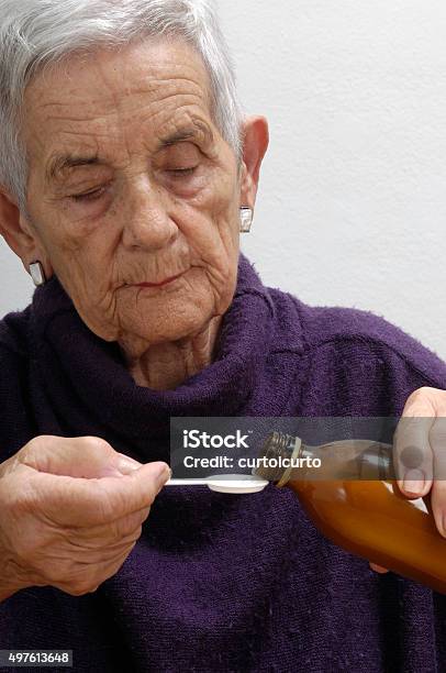 Senior Woman Taking Syrup Stock Photo - Download Image Now - 2015, Adult, Adults Only