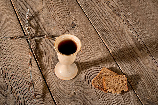 istock Chalice and bread on the wooden table 497613832