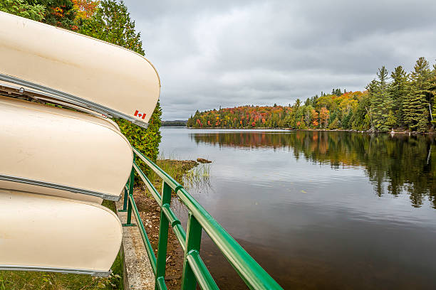 istock Canoes Stored on a Rack Overlooking a Lake in Autumn 497615008