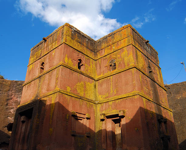 Lalibela, Ethiopia: rock-hewn Church of Saint George Lalibela, Amhara region, Ethiopia: rock-hewn Church of Saint George / Biete Giyorgis - carved from red volcanic rock in the shape of a cross - 12th century - the most famous of the eleven monolithic churches in Lalibela - Ethiopian Orthodox Tewahedo Church - UNESCO world heritage site - photo by M.Torres the church of saint george lalibela ethiopia stock pictures, royalty-free photos & images